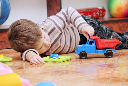 Little Boy Playing with Toy Car
